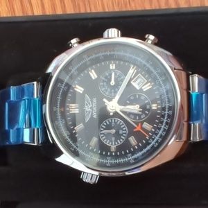 Aviator brand Swiss watch with silver dial and band. Roman numeral numbers.